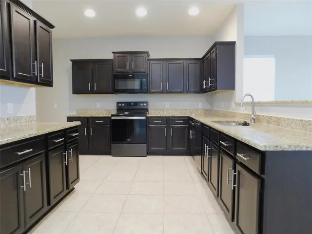 a kitchen with stainless steel appliances granite countertop a sink and cabinets