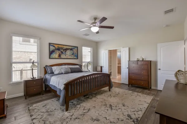 a bedroom with a bed and a chandelier