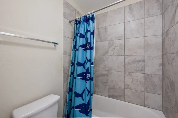 a bathroom with a shower and a toilet