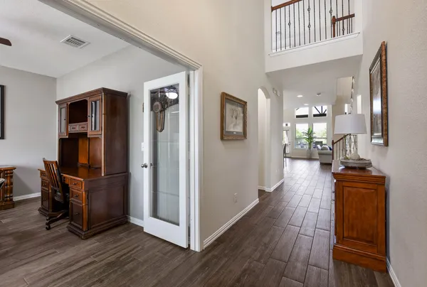 a view of a living room with wooden floor and furniture