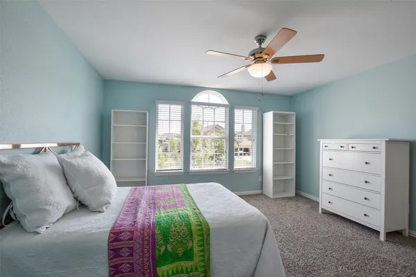a bedroom with a large bed and a window
