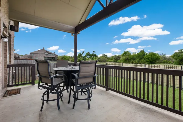 a view of a chairs and table in patio
