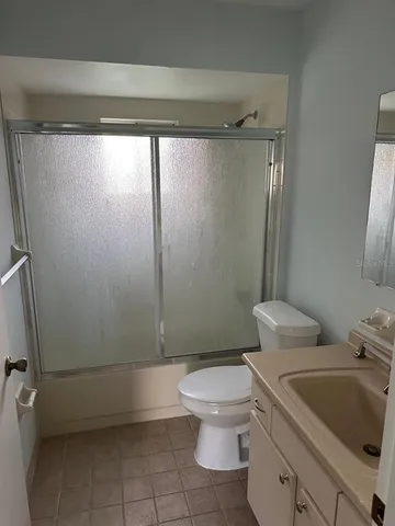 a white toilet sitting next to a bathroom sink and tub