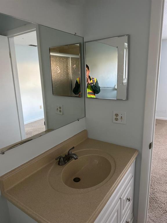 11248 Southwest 76th Terrace Ocala, FL 34476 - Photo 15 of 17 a bathroom with a sink and a mirror