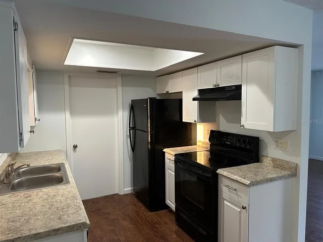 a kitchen with a refrigerator stove and sink