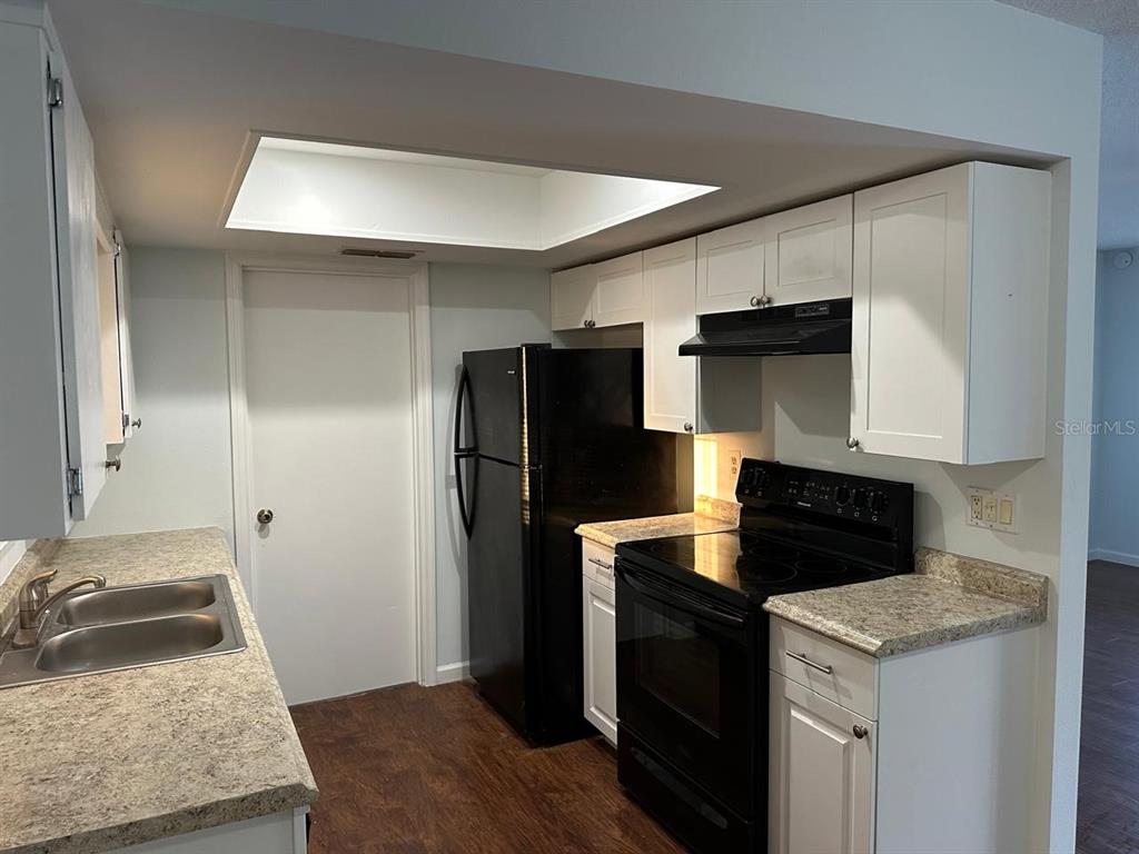 11248 Southwest 76th Terrace Ocala, FL 34476 - Photo 5 of 17 a kitchen with a refrigerator stove and sink