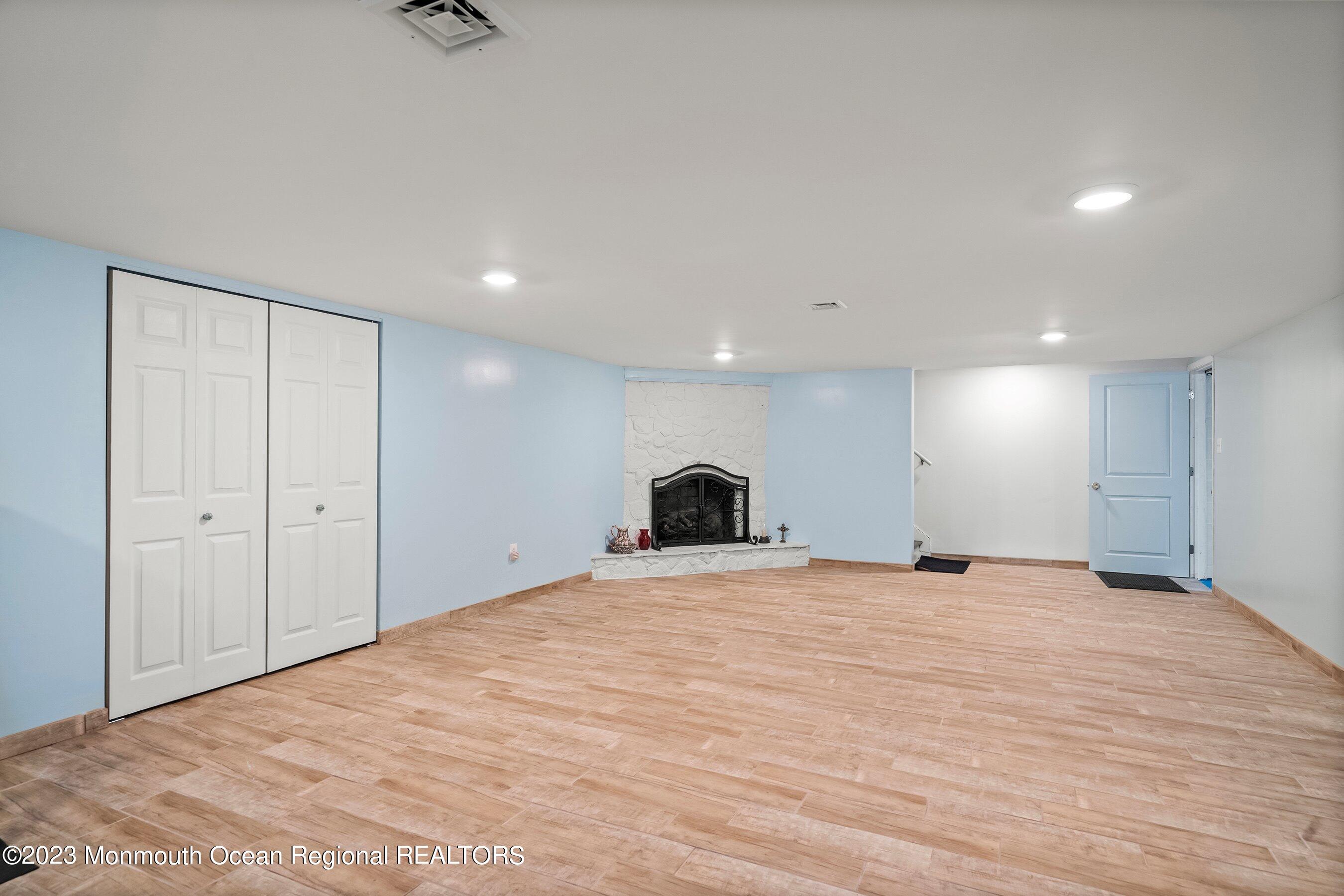 655 Burke Road Jackson, NJ 08527 - Photo 15 of 23 a view of an empty room with a fireplace and a window