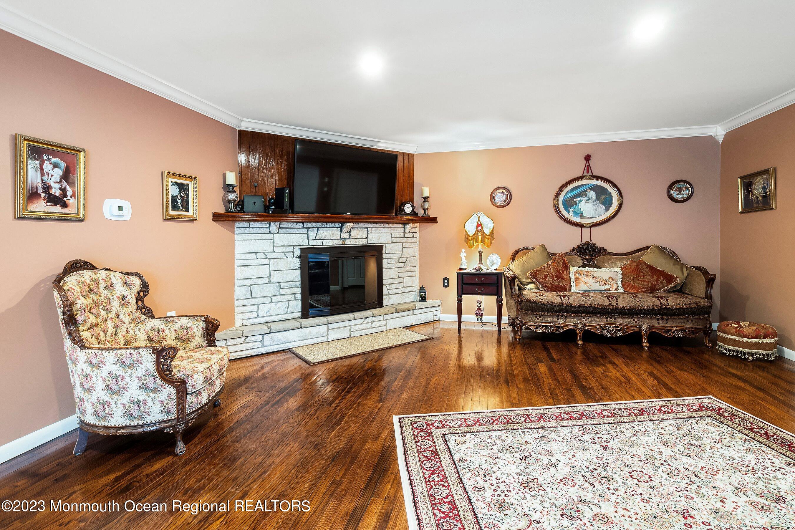 655 Burke Road Jackson, NJ 08527 - Photo 3 of 23 a living room with furniture and a fireplace