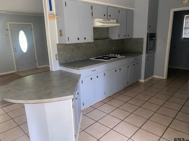 a kitchen with stainless steel appliances granite countertop a sink and a stove