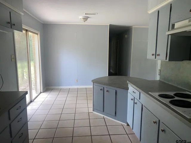 a kitchen with a sink a refrigerator and window