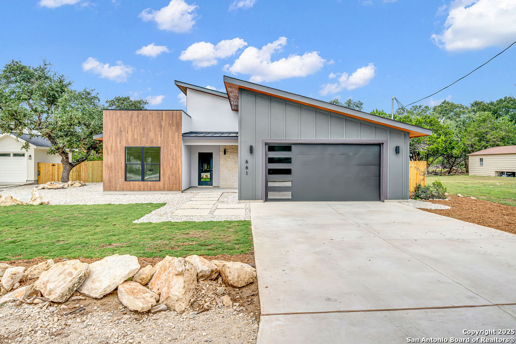 661 Jonquil Drive Spring Branch, TX 78070 - Photo 1 of 18 a front view of a house with a yard and garage