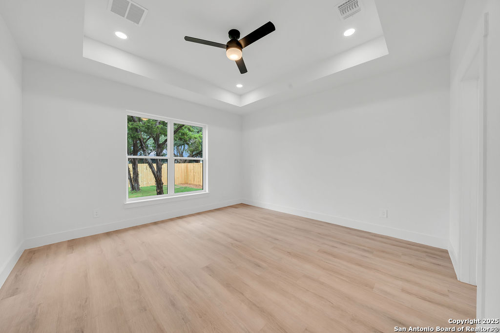 661 Jonquil Drive Spring Branch, TX 78070 - Photo 12 of 18 an empty room with windows and ceiling fan