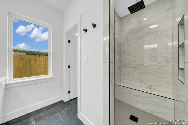 a bathroom with a bathtub and a shower