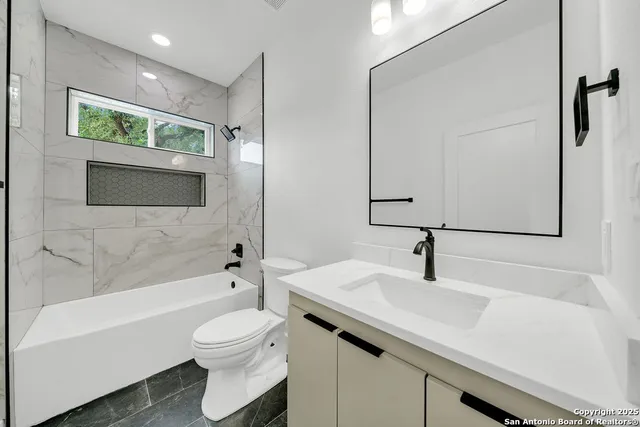 a bathroom with a sink a toilet and a bathtub