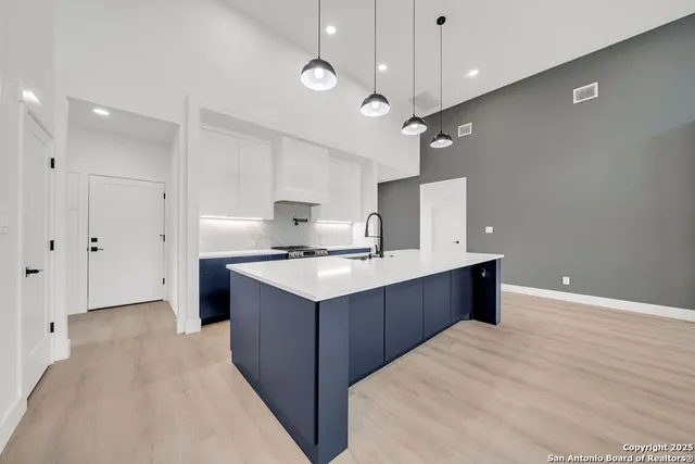 a kitchen with a stove kitchen island and stainless steel appliances