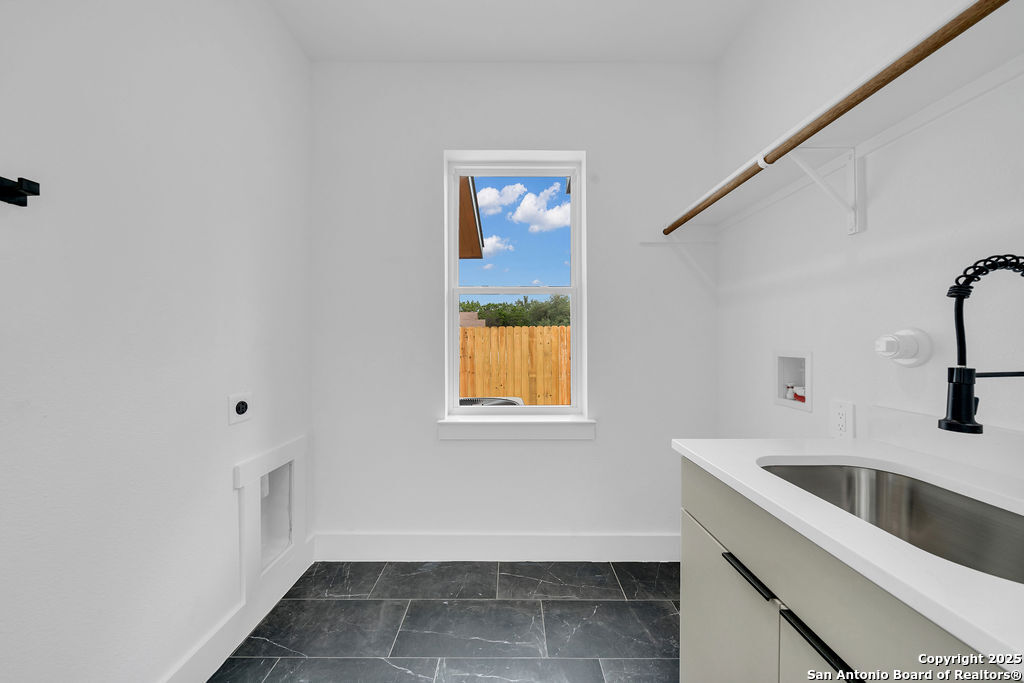 661 Jonquil Drive Spring Branch, TX 78070 - Photo 8 of 18 a view of a kitchen that shows a sink and dishwasher with wooden floor