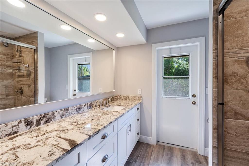 4231-4241 Orange River Loop Road Fort Myers, FL 33905 - Photo 12 of 50 a bathroom with a granite countertop sink and a large mirror