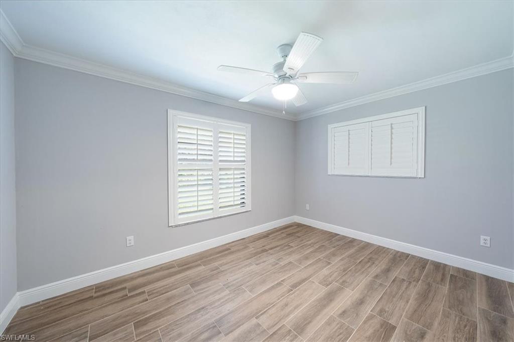 4231-4241 Orange River Loop Road Fort Myers, FL 33905 - Photo 14 of 50 a view of an empty room with wooden floor and a window