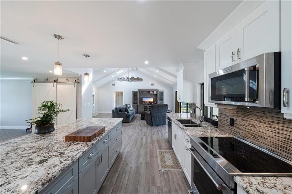 4231-4241 Orange River Loop Road Fort Myers, FL 33905 - Photo 18 of 50 a large kitchen with a large counter top space appliances and cabinets