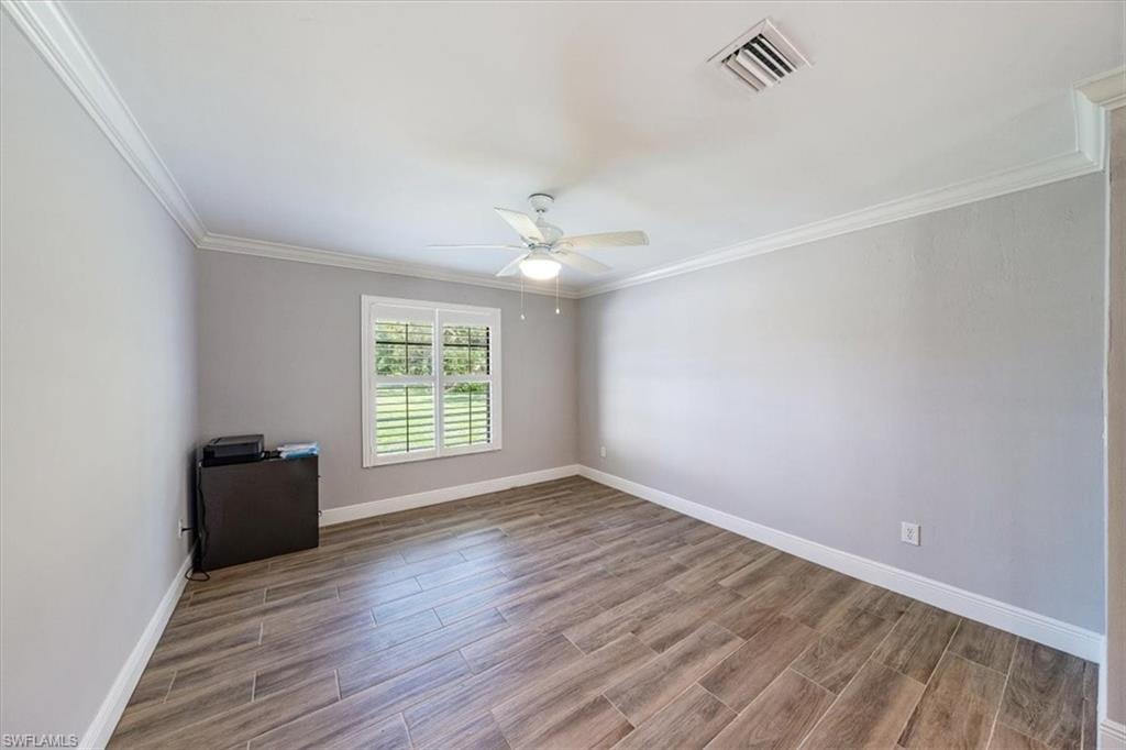 4231-4241 Orange River Loop Road Fort Myers, FL 33905 - Photo 19 of 50 an empty room with wooden floor and windows