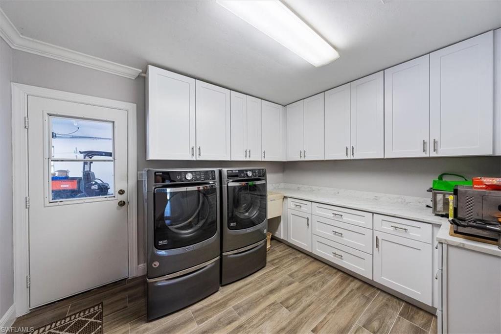 4231-4241 Orange River Loop Road Fort Myers, FL 33905 - Photo 20 of 50 a kitchen with stainless steel appliances white cabinets and a refrigerator