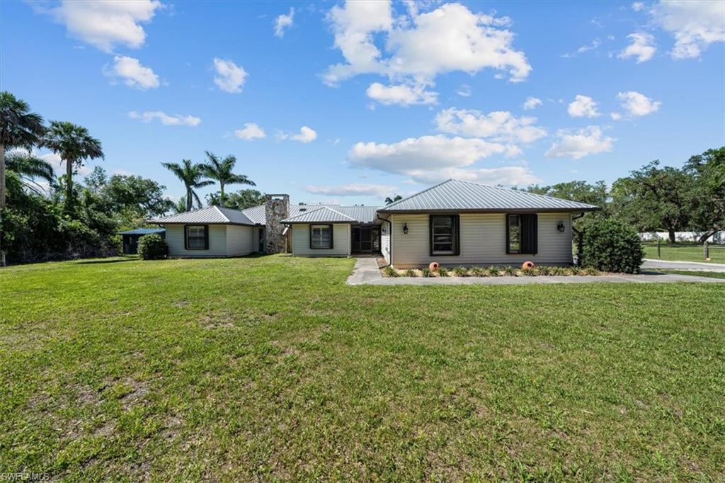 4231-4241 Orange River Loop Road Fort Myers, FL 33905 - Photo 2 of 50 a front view of a house with garden
