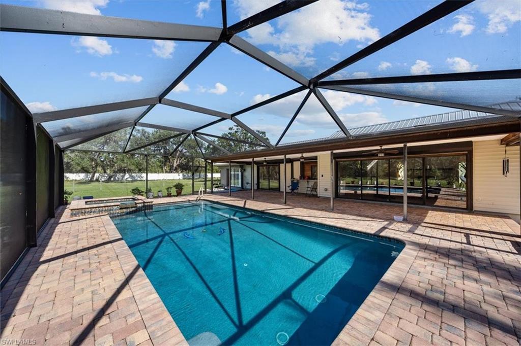 4231-4241 Orange River Loop Road Fort Myers, FL 33905 - Photo 21 of 50 a view of a swimming pool with a porch