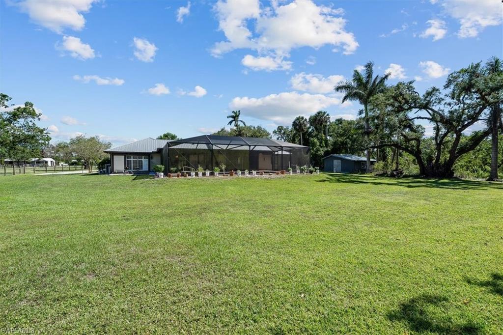 4231-4241 Orange River Loop Road Fort Myers, FL 33905 - Photo 22 of 50 a view of a house with a yard