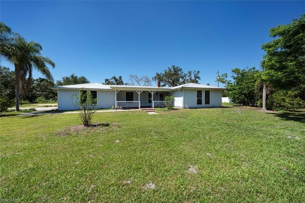 4231-4241 Orange River Loop Road Fort Myers, FL 33905 - Photo 26 of 50 a front view of house with yard and green space