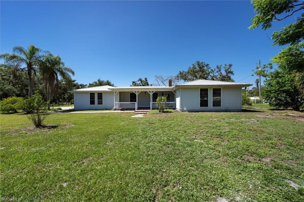 4231-4241 Orange River Loop Road Fort Myers, FL 33905 - Photo 27 of 50 a front view of a house with a garden