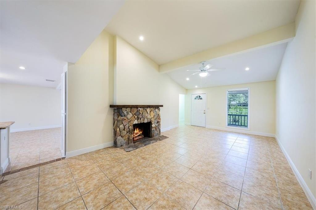 4231-4241 Orange River Loop Road Fort Myers, FL 33905 - Photo 30 of 50 an empty room with windows and fireplace