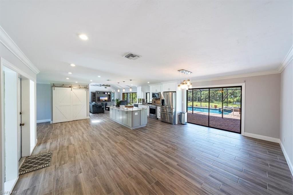 4231-4241 Orange River Loop Road Fort Myers, FL 33905 - Photo 3 of 50 a living room with furniture and hard wood flooring