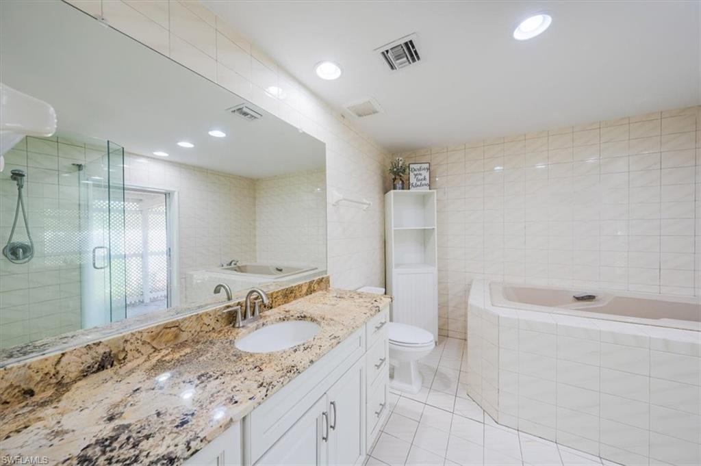 4231-4241 Orange River Loop Road Fort Myers, FL 33905 - Photo 34 of 50 a bathroom with a granite countertop sink mirror and a bathtub