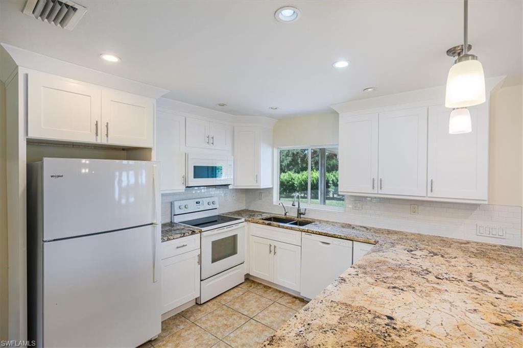 4231-4241 Orange River Loop Road Fort Myers, FL 33905 - Photo 36 of 50 a kitchen with white cabinets stainless steel appliances and sink