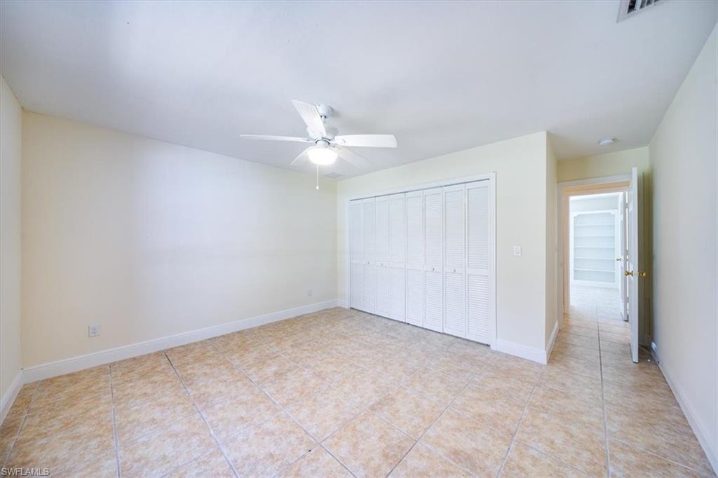 4231-4241 Orange River Loop Road Fort Myers, FL 33905 - Photo 42 of 50 an empty room with a ceiling fan and a window