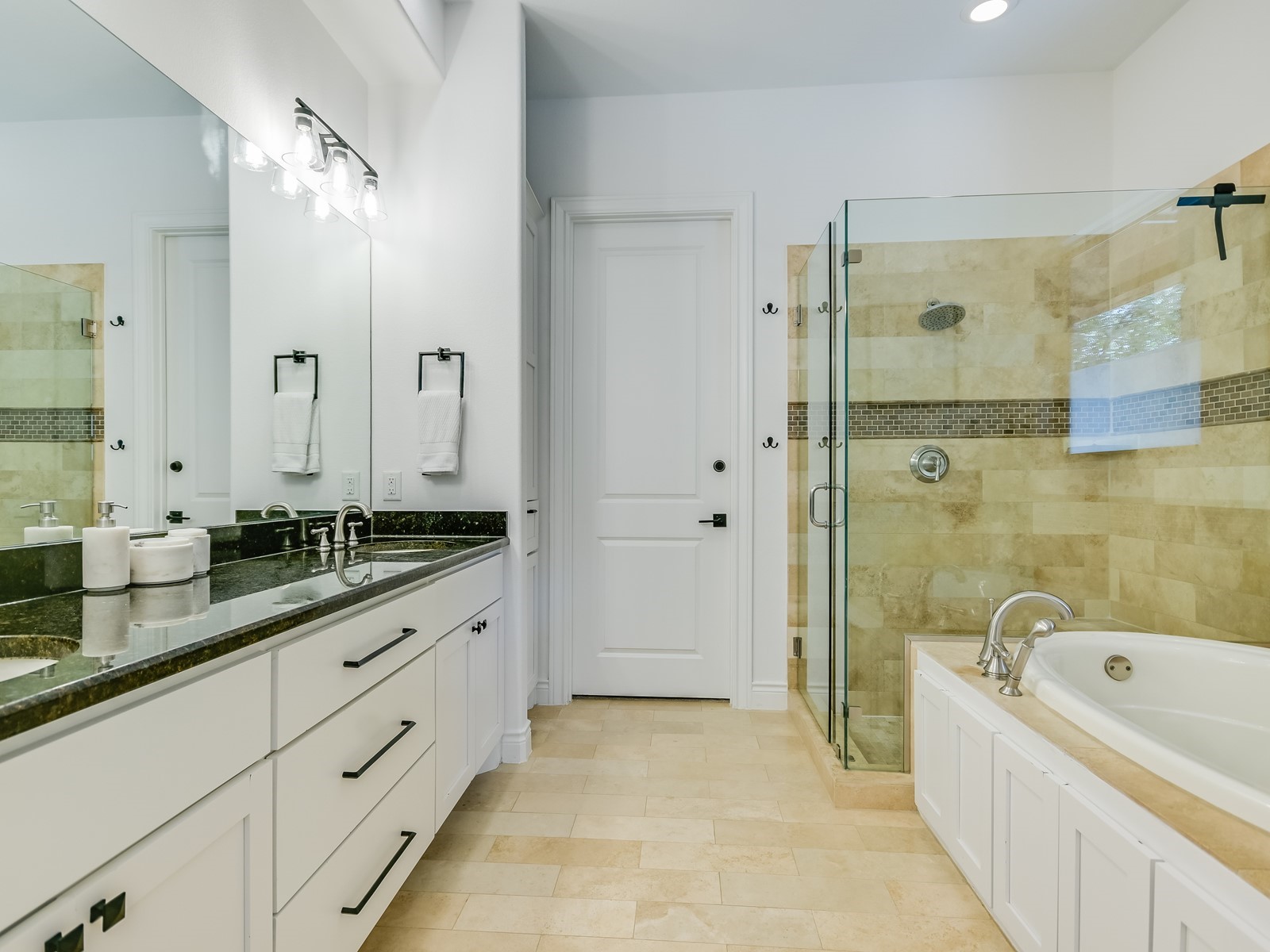 809 Kinney Avenue Austin, TX 78704 - Photo 15 of 21 a bathroom with a granite countertop tub sink shower and mirror