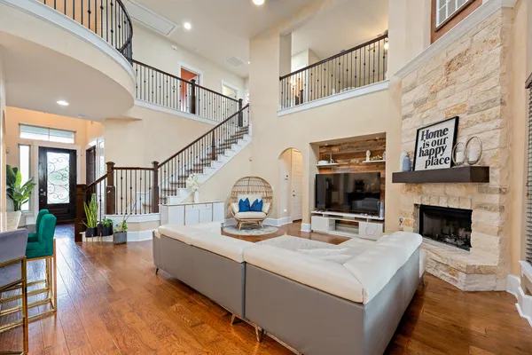 a living room with fireplace furniture and a wooden floor