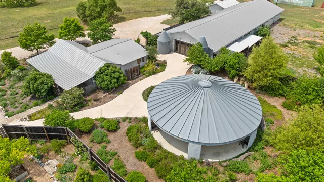 an aerial view of a house with a yard and lake view