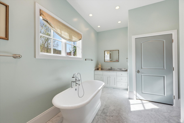 930 Price Farm Court Midway, UT 84049 - Photo 25 of 42 Master bathroom with vanity, a soaking tub, light marble finish flooring, and recessed lighting