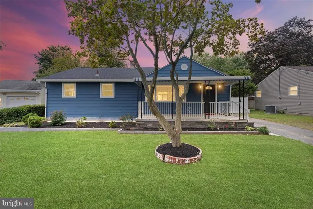 a front view of a house with a yard fire pit and outdoor seating