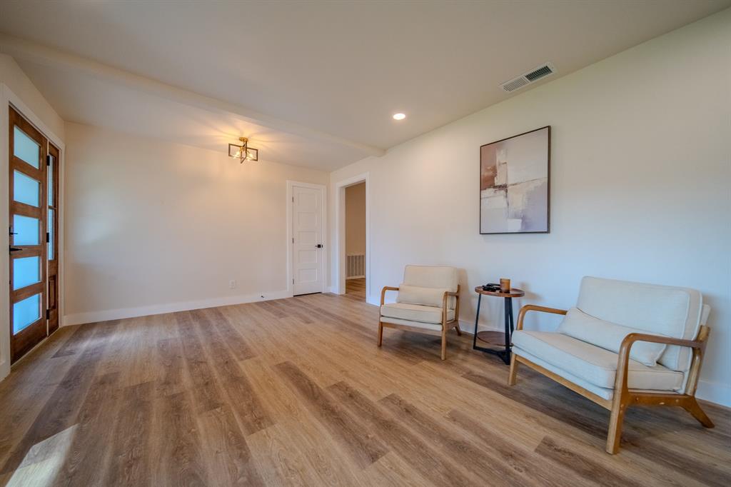 5125 Ashbrook Road Dallas, TX 75227 - Photo 5 of 34 Wood-finish flooring, recessed lighting, and a modern ceiling fixture illuminate this open space