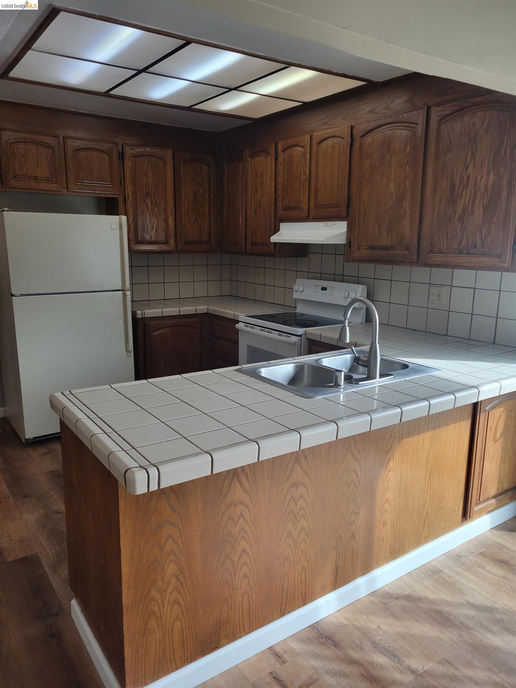 906 Coral Drive Rodeo, CA 94572 - Photo 6 of 21 a kitchen with a sink cabinets and stainless steel appliances
