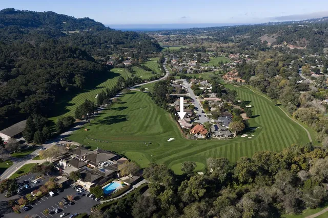 an aerial view of a golf course with parking space