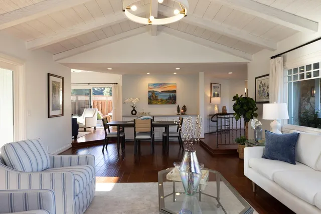 a living room with furniture wooden floor and a chandelier