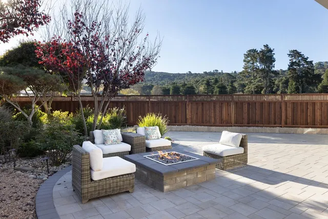 a patio with hardwood table and chairs