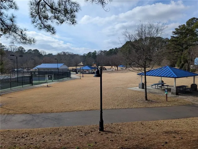 a kitchen with a sink stove top oven and cabinets