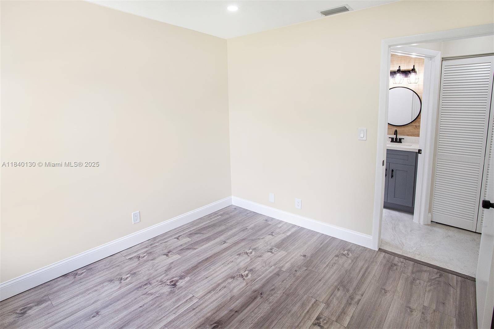 9431 Boca Cove Circle, Unit 1009 Boca Raton, FL 33428 - Photo 19 of 30 a view of empty room with wooden floor
