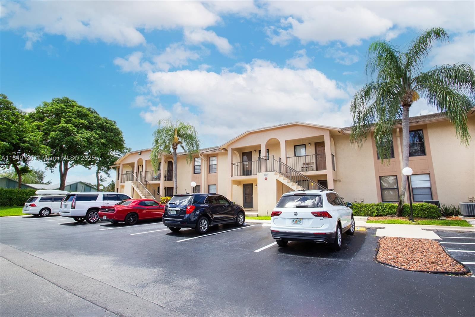 9431 Boca Cove Circle, Unit 1009 Boca Raton, FL 33428 - Photo 28 of 30 a car parked in front of a cars parked in front of a building