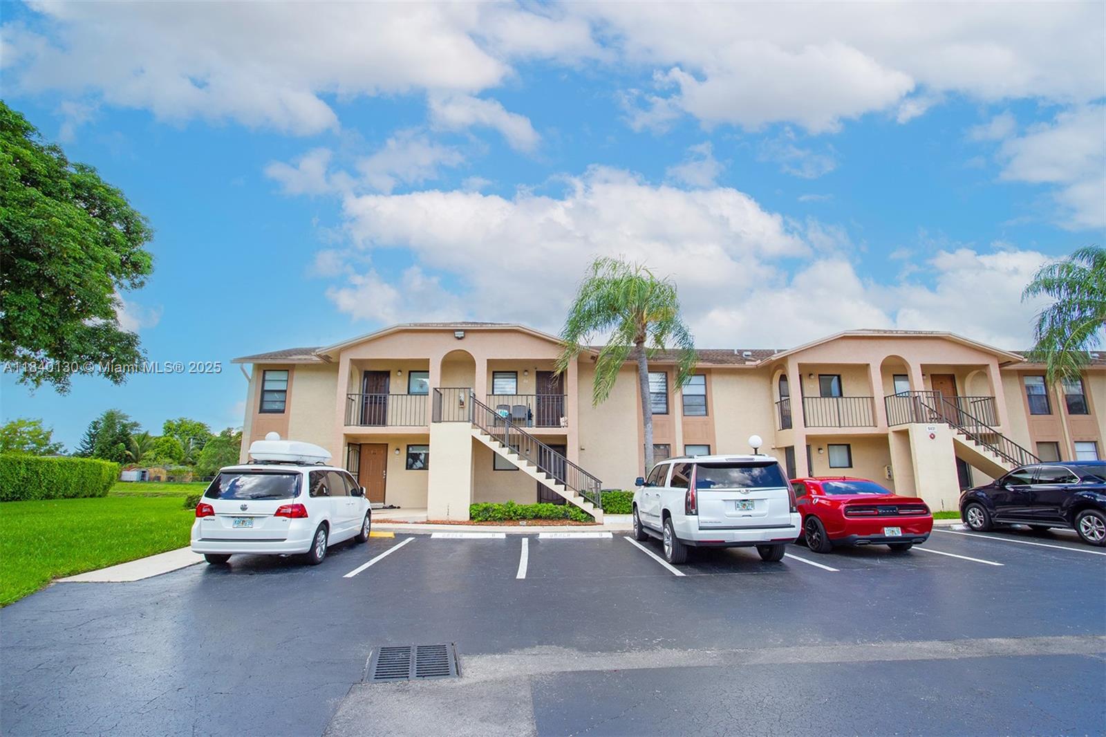 9431 Boca Cove Circle, Unit 1009 Boca Raton, FL 33428 - Photo 29 of 30 a car parked in front of a house
