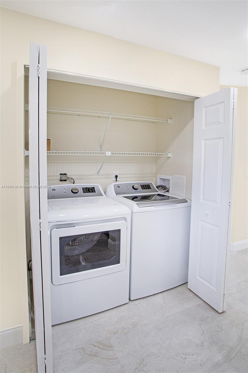 9431 Boca Cove Circle, Unit 1009 Boca Raton, FL 33428 - Photo 6 of 30 a utility room with washer and dryer